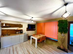 a kitchen with a table and a dining room at Roots Apartment 2 in Borovets