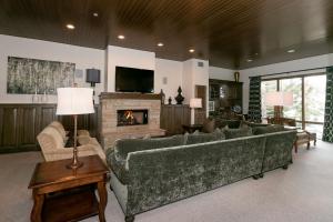 a living room with a couch and a fireplace at Premium Luxury Three Bedroom Suite with Hot Tub apartment hotel in Park City