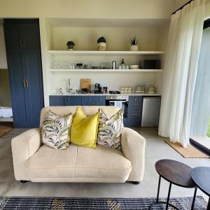 a living room with a couch and a kitchen at Little Prestwick on Gowrie Farm, Nottingham Road in Nottingham Road