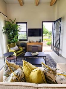 a living room with a couch and a tv at Little Prestwick on Gowrie Farm, Nottingham Road in Nottingham Road