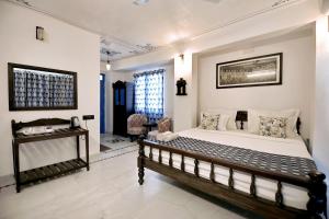 a bedroom with a large bed in a room at The Lake View Hotel- On Lake Pichola in Udaipur