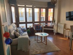 a living room with a couch and a table at Apartamento Cine Colón 2 in Ribadeo