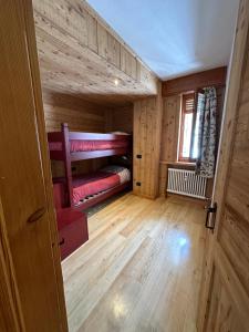 a room with two bunk beds in a cabin at Casa Olivera in Limone Piemonte