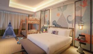 Postel nebo postele na pokoji v ubytování 银都酒店 Yandoo Hotel
