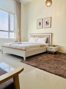 a bedroom with a bed and a large window at Abu Rakan Apartment in Muscat