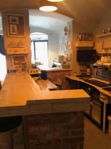 a kitchen with a wooden counter top in a room at Godot Apartman in Miskolc
