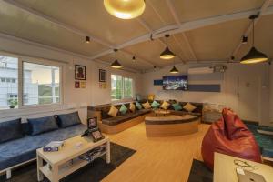 a living room with a couch and a table at Zostel Hyderabad in Hyderabad