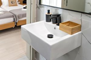 a white sink in a room with a bed at Nina's House in Achladies +203 photos