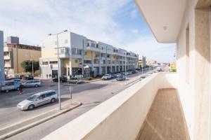 a view of a city street with cars and buildings at Casa Armonia by MONHOLIDAY in Monopoli