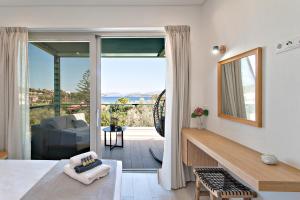 a bedroom with a view of a living room at Nina's House in Achladies
