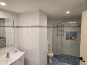 a bathroom with a shower and a toilet and a sink at Penthouse in Surfers Hawaiian Holiday Apartments in Gold Coast +76 photos
