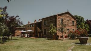 a large brick house with a yard in front of it at Agriturismo Cerqueto in Acquapendente