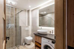 a bathroom with a sink and a washing machine at One bedroom apartment in Dolný Kubín