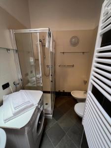 a bathroom with a shower and a washing machine at Camping Dolomiti in Dimaro