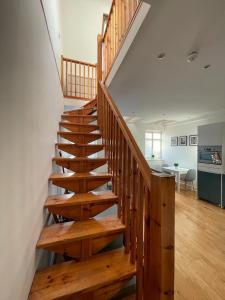 a wooden staircase in a house with a kitchen at Gateforth Flat-Lovely 1 Bed in the heart of Central London in London