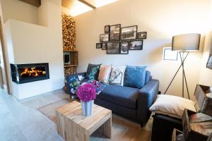 a living room with a couch and a fireplace at Kellerstöckl Heuberger in Eltendorf