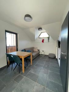 a living room with a table and a couch at Sunshine Apartments Golte C1 in Mozirje