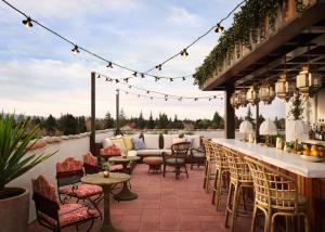 a patio with chairs and a bar with a view at Graduate Palo Alto in Palo Alto