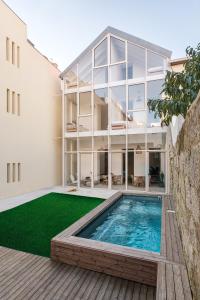 a house with a swimming pool and a building at Ocean Porto - Beach House in Matosinhos