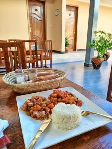 a plate of rice and food on a table at Kendwa Cool and Calm Hotel limited in Kendwa +19 photos