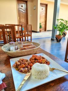 a plate of rice and food on a table at Kendwa Cool and Calm Hotel limited in Kendwa