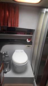 a small bathroom with a white toilet in a room at Blacky in Bodrum City
