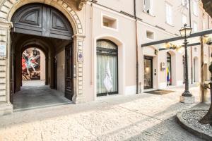 an empty street with buildings and a street light at Best Western Premier Milano Palace Hotel in Modena