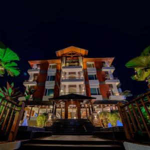 a hotel building with stairs in front of it at night at Godwin Candolim,Goa in Candolim