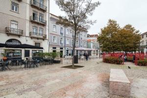 a town square with tables and chairs and buildings at Lisbon Intendente Terrace Apartment with BBQ in Lisbon