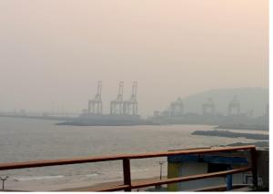 a foggy view of a harbor with a ship in the water at Nandita S Beach Bay Rest House By WB Inn in Visakhapatnam