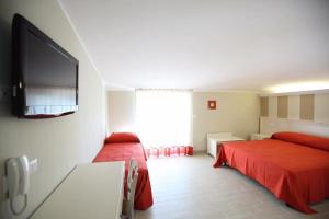 Hotel Al Rustico في Crosia: غرفة نوم بسريرين وتلفزيون بشاشة مسطحة
