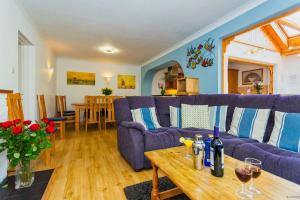 a living room with a purple couch and a table at CROYDE VILLA SUNSEA 6 Bedrooms in Croyde