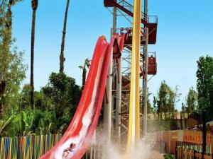 a red slide at a park with a water fountain at APARTBEACH SALOU y PLAYA 742 in Salou