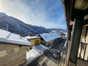 a view of a street with snow covered buildings at Home holidays- attico arc en ciel in Sestriere