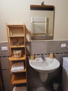 a bathroom with a sink and a mirror at Home holidays- attico arc en ciel in Sestriere