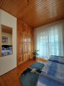 a bedroom with a bed and a wooden ceiling at Apartmani Milicevic Zlatibor in Zlatibor