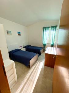 A bed or beds in a room at NaturAmare Apartments Palinuro