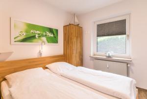 a bedroom with a bed and a window at "Ferienwohnug Bambergers" Ferienwohnung Bamberger s in Büsumer Deichhausen