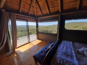 a room with a couch in a room with windows at Harmony Luxury Tents & Safari in Addo