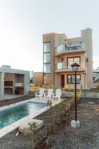 una casa con piscina frente a una casa en Terrazas del Ayuí en Concordia