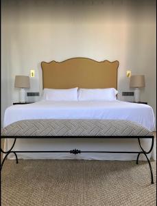 a large bed in a bedroom with two lamps at Soho Boutique Castillo de Santa Catalina - Adults Recommended in Málaga