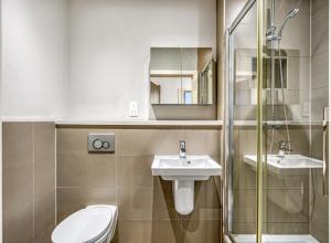 a bathroom with a toilet and a sink and a shower at Stylish Studio by Heathrow Airport in London