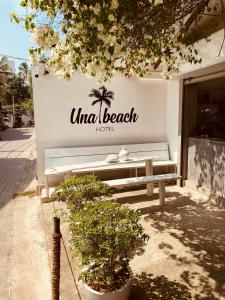 a bench sitting on the side of a building at Una Beach Hotel & OLU Cafe in Unawatuna
