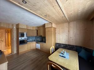 a kitchen with a table and a counter top at Kuanerhof Wohnung 2 Personen in Ried im Zillertal