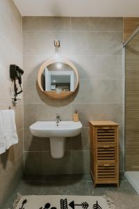 a bathroom with a sink and a mirror at Natural Stay Apartamentos PassivHaus in Logroño