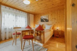 a bedroom with a bed and a table and chairs at Haus Wilma in Schruns
