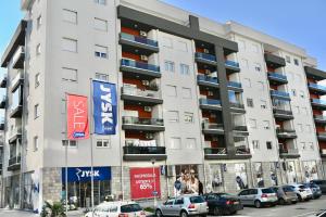a large apartment building with cars parked in front of it at Apartment Lola in Trebinje