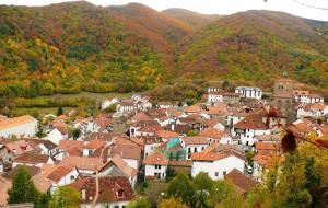 a town in the mountains with red roofs at Pension Txiki in Isaba
