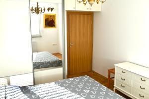 a bedroom with a closet and a bed and a mirror at Apartment Lola in Trebinje