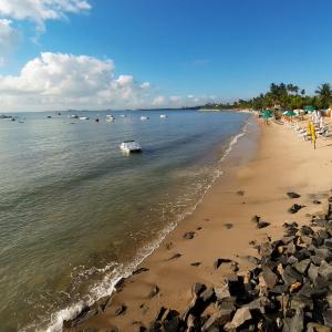 un barco en el agua en una playa en Eco chalés 1 e 2 en Cabo de Santo Agostinho